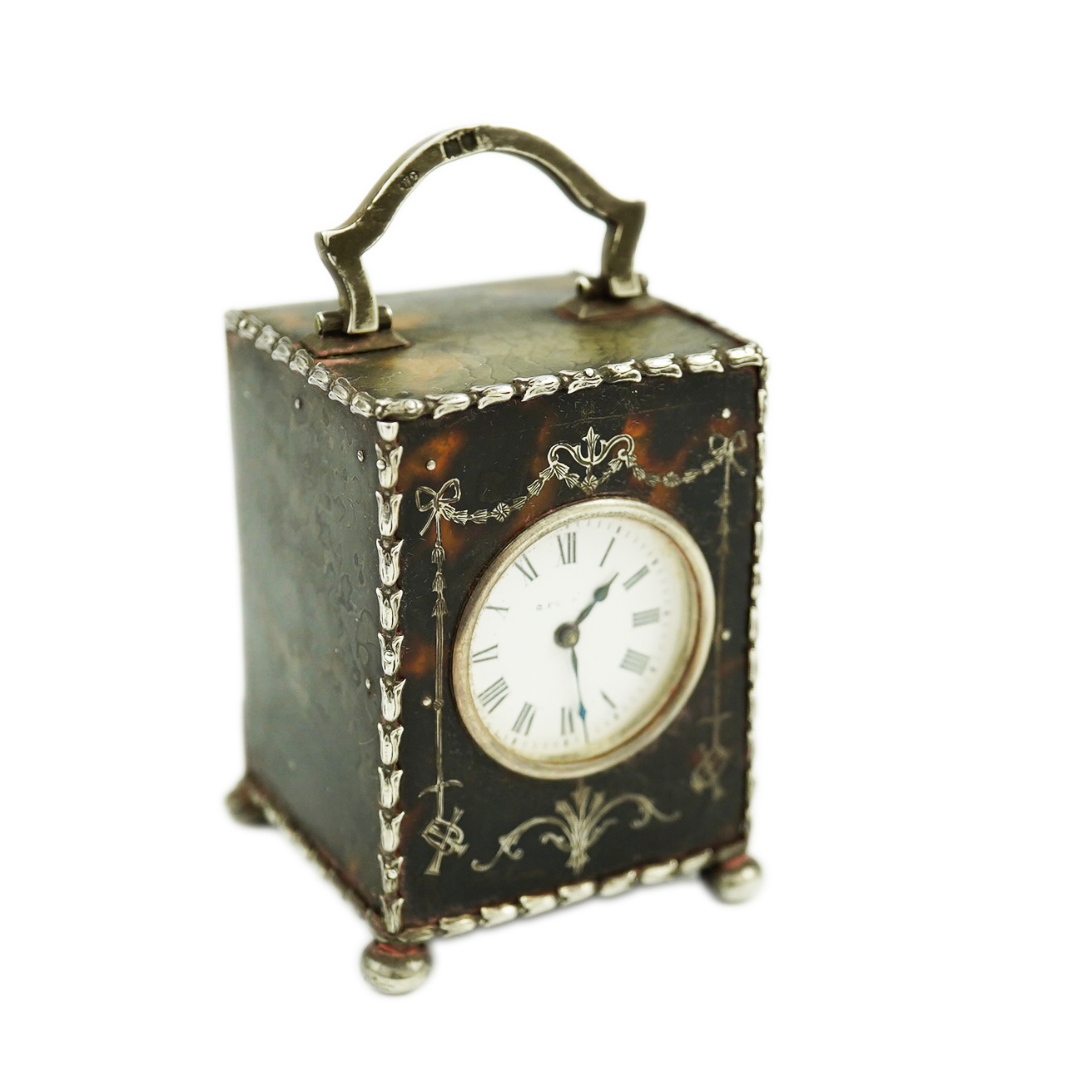 An Edwardian silver mounted tortoiseshell miniature carriage timepiece, by William Comyns